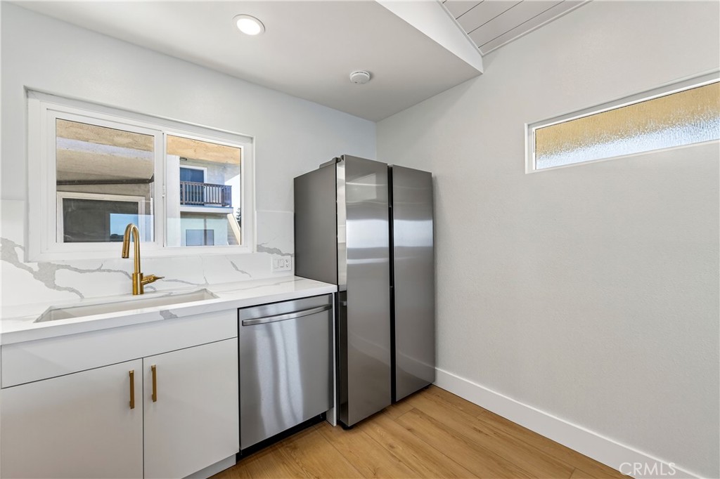 34381 Dana Strand Road, Unit 2 Dana Point, CA 92629 - Photo 11 of 42 a kitchen with a sink and refrigerator
