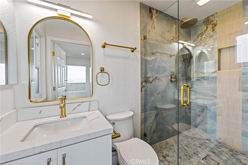 34381 Dana Strand Road, Unit 2 Dana Point, CA 92629 - Photo 22 of 42 a bathroom with a sink a toilet and shower