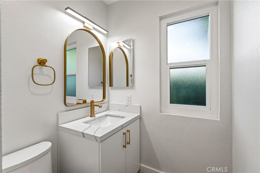 34381 Dana Strand Road, Unit 2 Dana Point, CA 92629 - Photo 26 of 42 a bathroom with a granite countertop sink and a mirror