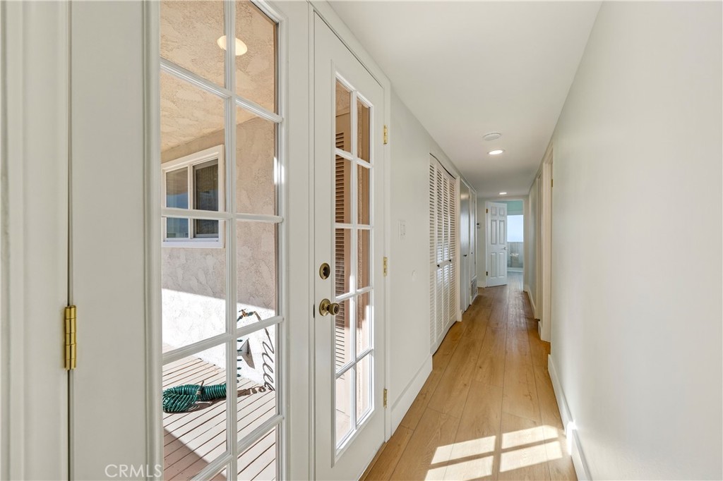34381 Dana Strand Road, Unit 2 Dana Point, CA 92629 - Photo 30 of 42 a view of a hallway with wooden floor and glass door