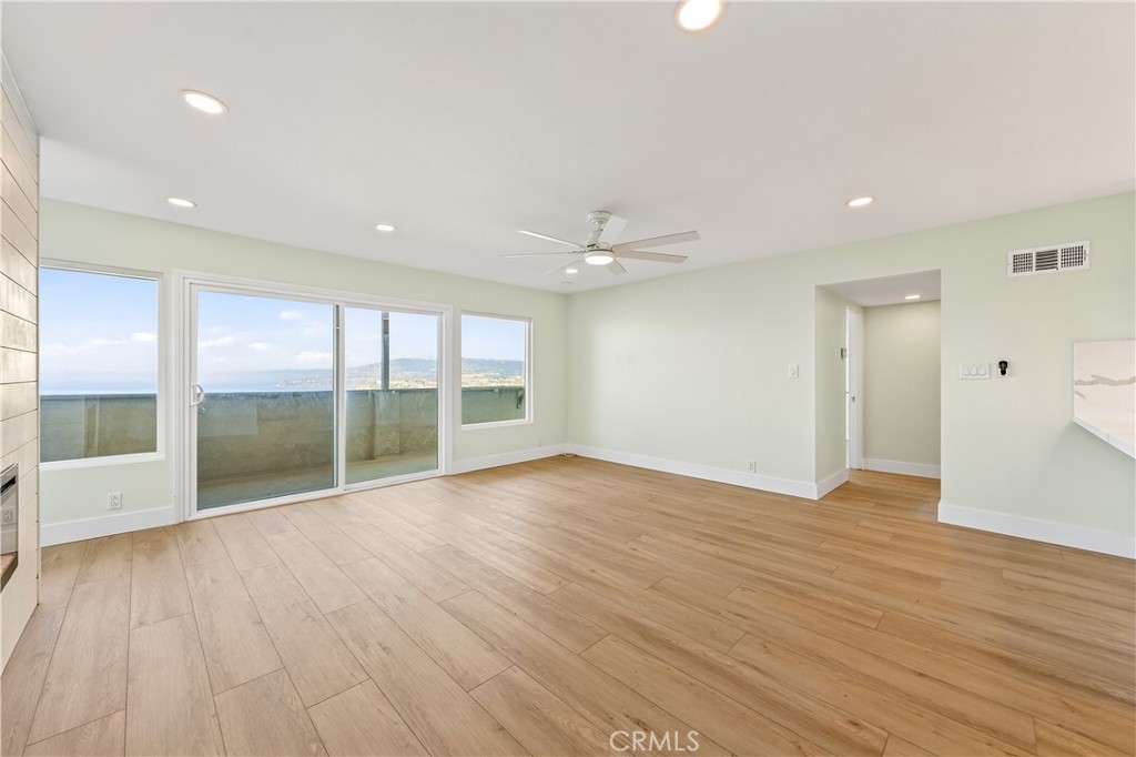 34381 Dana Strand Road, Unit 2 Dana Point, CA 92629 - Photo 3 of 42 a view of an empty room with wooden floor and a window