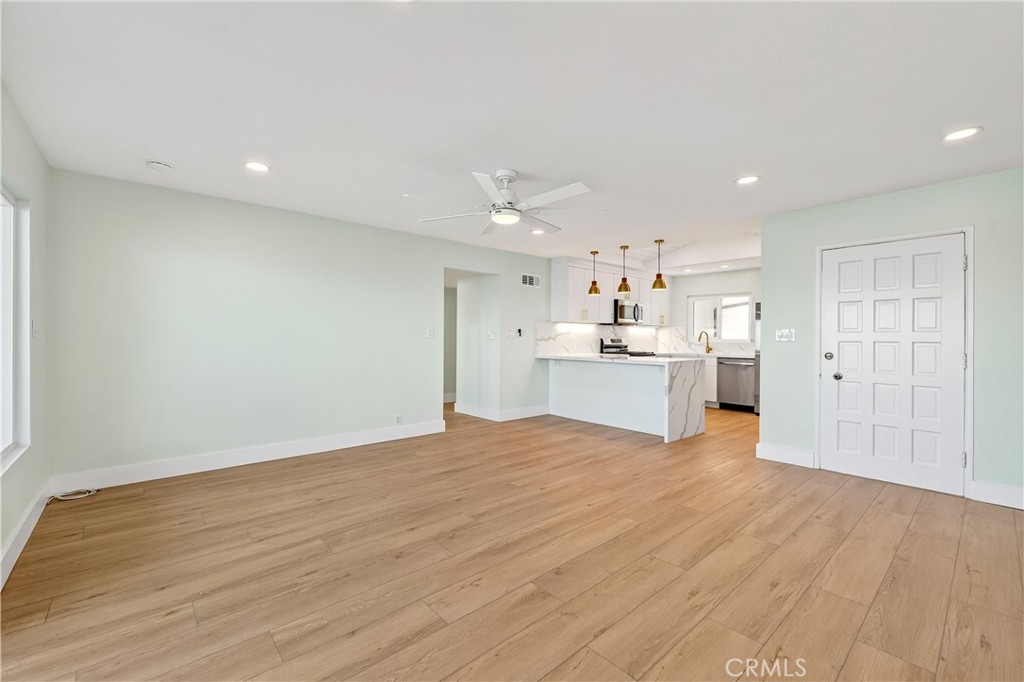 34381 Dana Strand Road, Unit 2 Dana Point, CA 92629 - Photo 4 of 42 a view of a kitchen with wooden floor and a kitchen