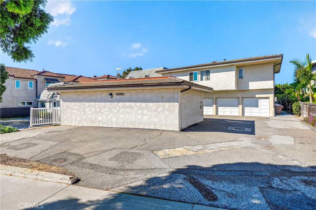 34381 Dana Strand Road, Unit 2 Dana Point, CA 92629 - Photo 42 of 42 a front view of a house with a yard and garage