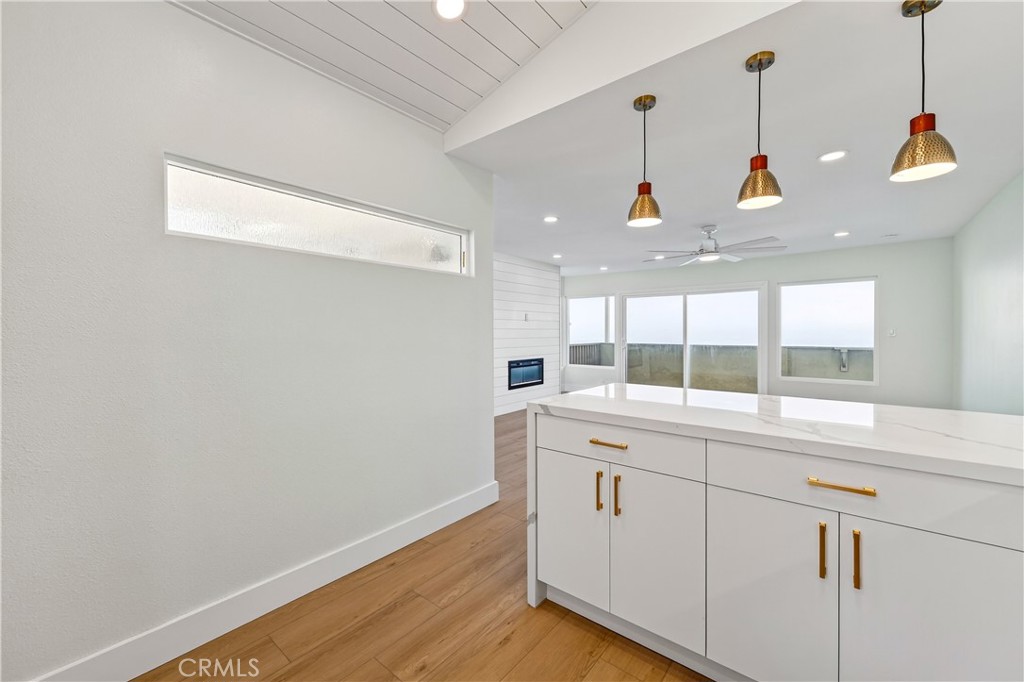 34381 Dana Strand Road, Unit 2 Dana Point, CA 92629 - Photo 9 of 42 a view of a kitchen with a sink and wooden floor