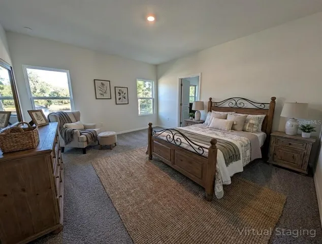a spacious bedroom with a bed couch and a window