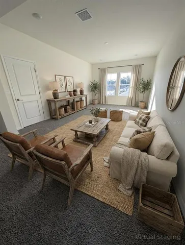 a living room with furniture a large window and a table