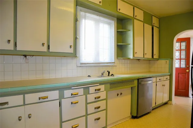 a kitchen with stainless steel appliances white cabinets and a sink