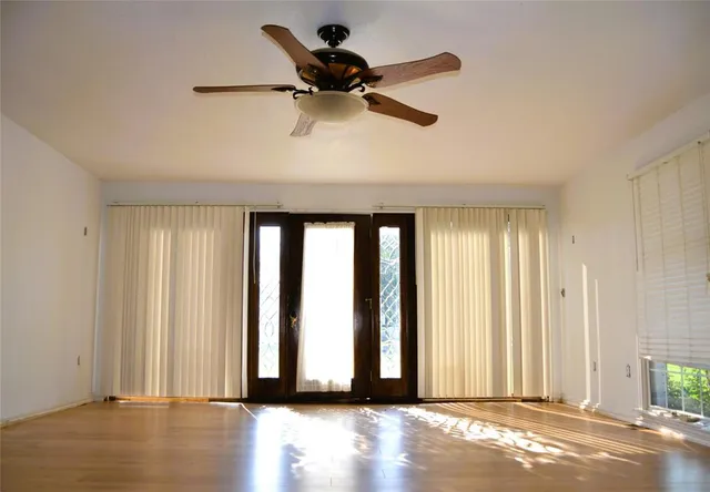 a view of wooden floor and windows in a room