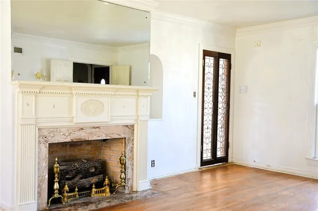 a view of a livingroom with a fireplace and window