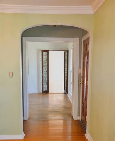 a view of a hallway with wooden floor