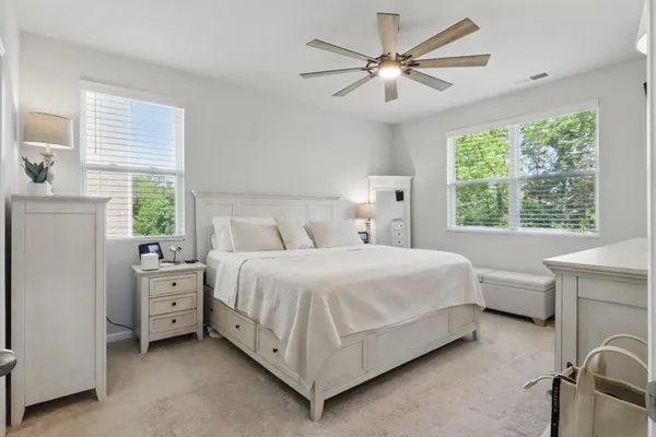 a bedroom with a bed and a large window