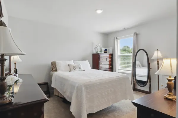 a bedroom with a bed and a table
