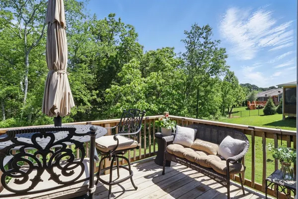 a view of a chairs and table in patio