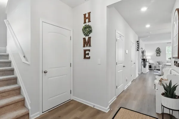 a view of a hallway view with wooden floor and staircase