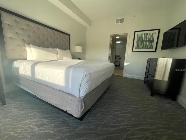 a bed room with a bed window and a mirror