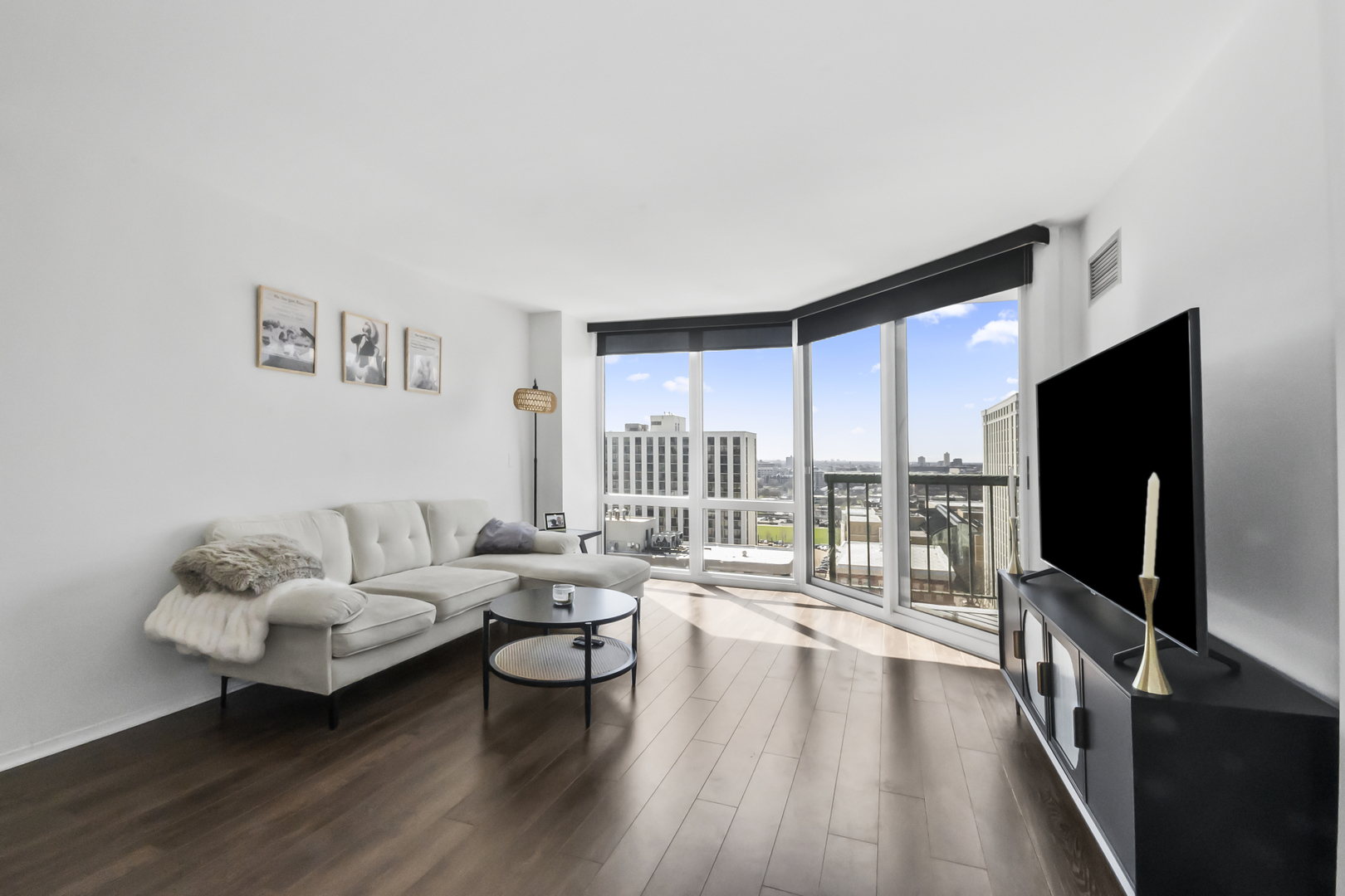 111 West Maple Street, Unit 1110 Chicago, IL 60610 - Photo 2 of 23 a living room with furniture and a flat screen tv