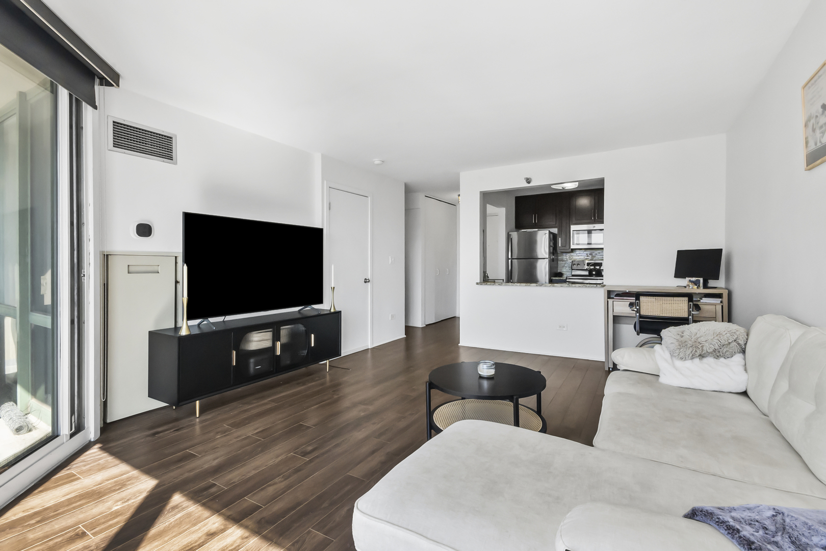 111 West Maple Street, Unit 1110 Chicago, IL 60610 - Photo 8 of 23 a living room with furniture and a flat screen tv
