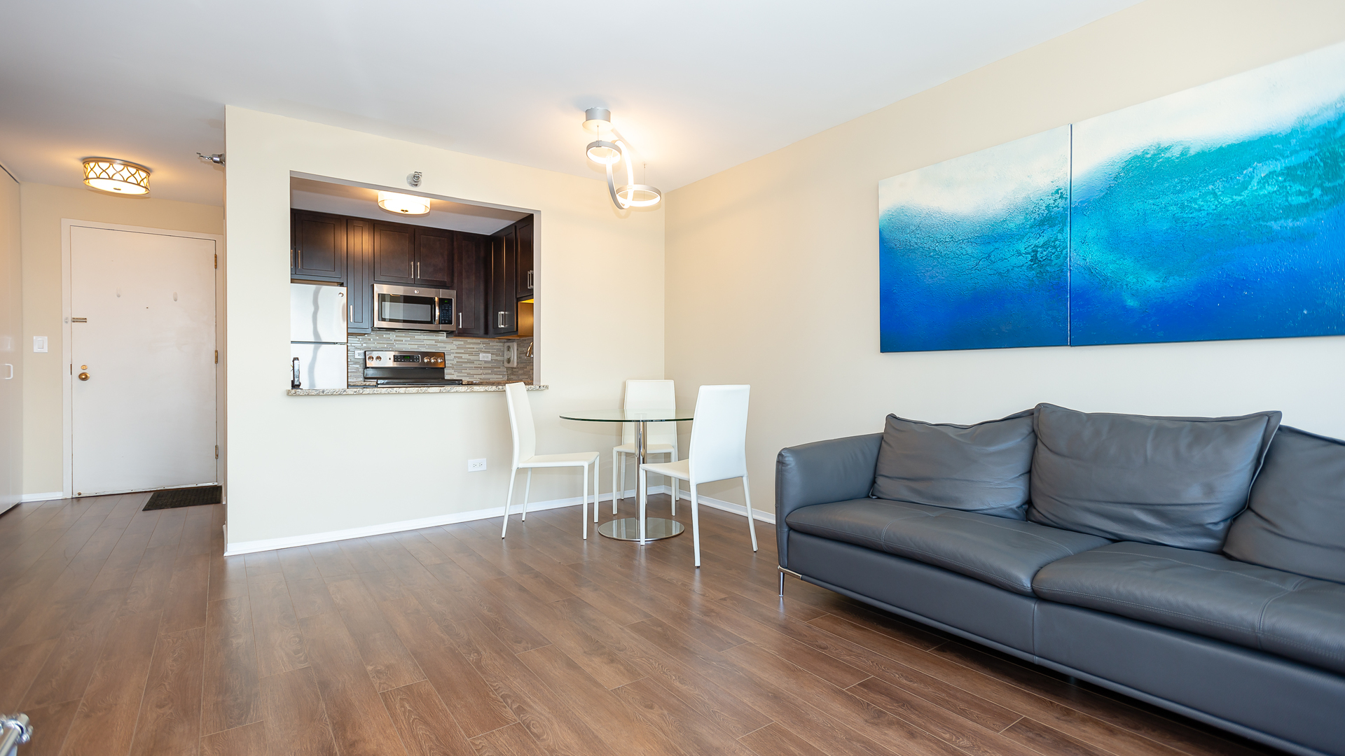 111 West Maple Street, Unit 1110 Chicago, IL 60610 - Photo 9 of 23 a living room with furniture and a wooden floor