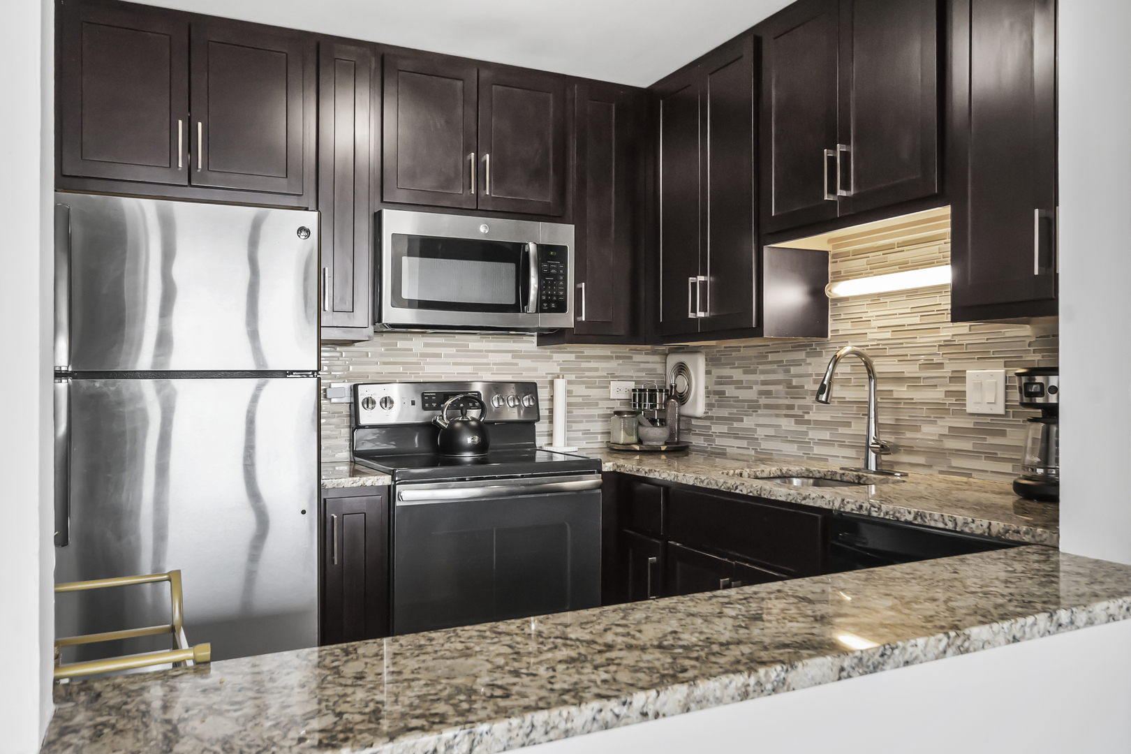 111 West Maple Street, Unit 1110 Chicago, IL 60610 - Photo 10 of 23 a kitchen with stainless steel appliances granite countertop a refrigerator and a sink