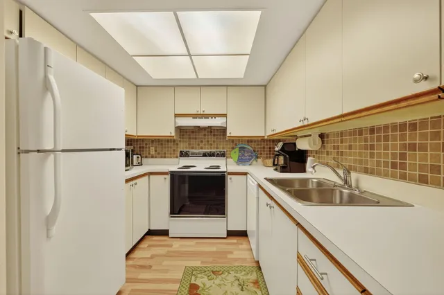 a kitchen with a sink cabinets and stainless steel appliances