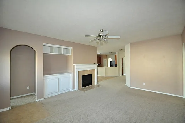 a view of empty room with a fireplace