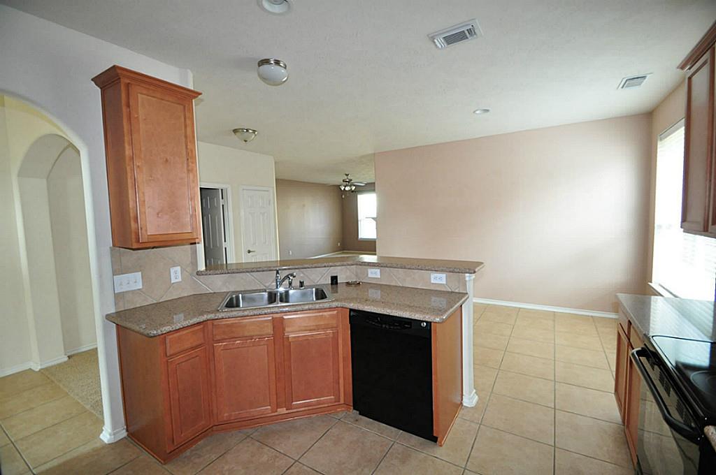 12315 Field Brook Court Houston, TX 77089 - Photo 2 of 28 a kitchen with a sink stove and cabinets