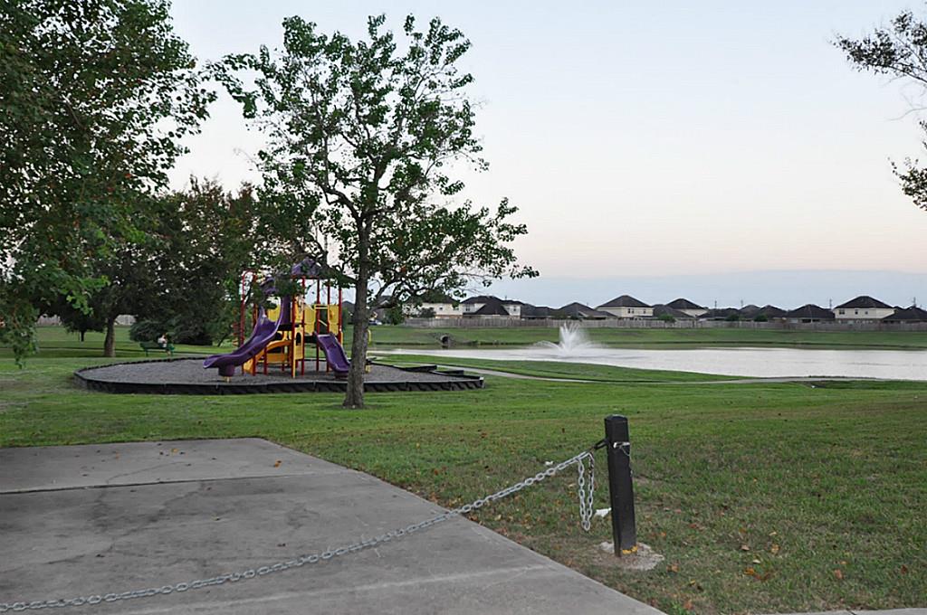 12315 Field Brook Court Houston, TX 77089 - Photo 21 of 28 a view of a lake with a yard and a large tree