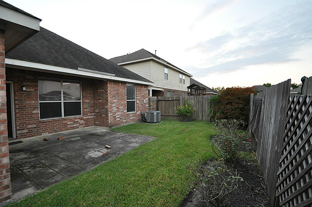 12315 Field Brook Court Houston, TX 77089 - Photo 23 of 28 a view of a yard in front of a house with large windows