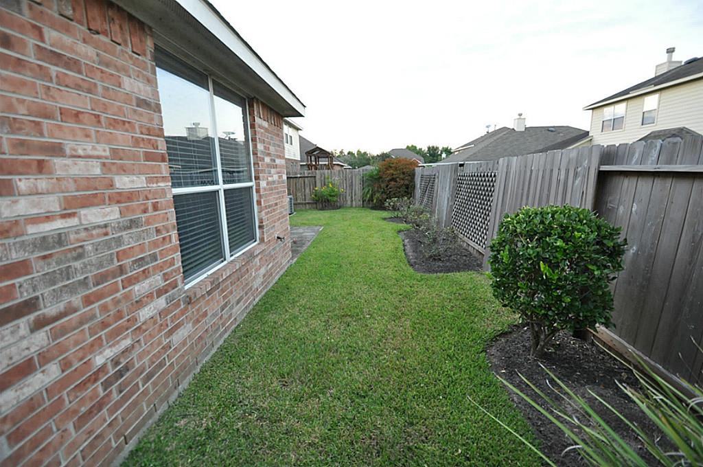 12315 Field Brook Court Houston, TX 77089 - Photo 25 of 28 a view of a house with a yard and plants