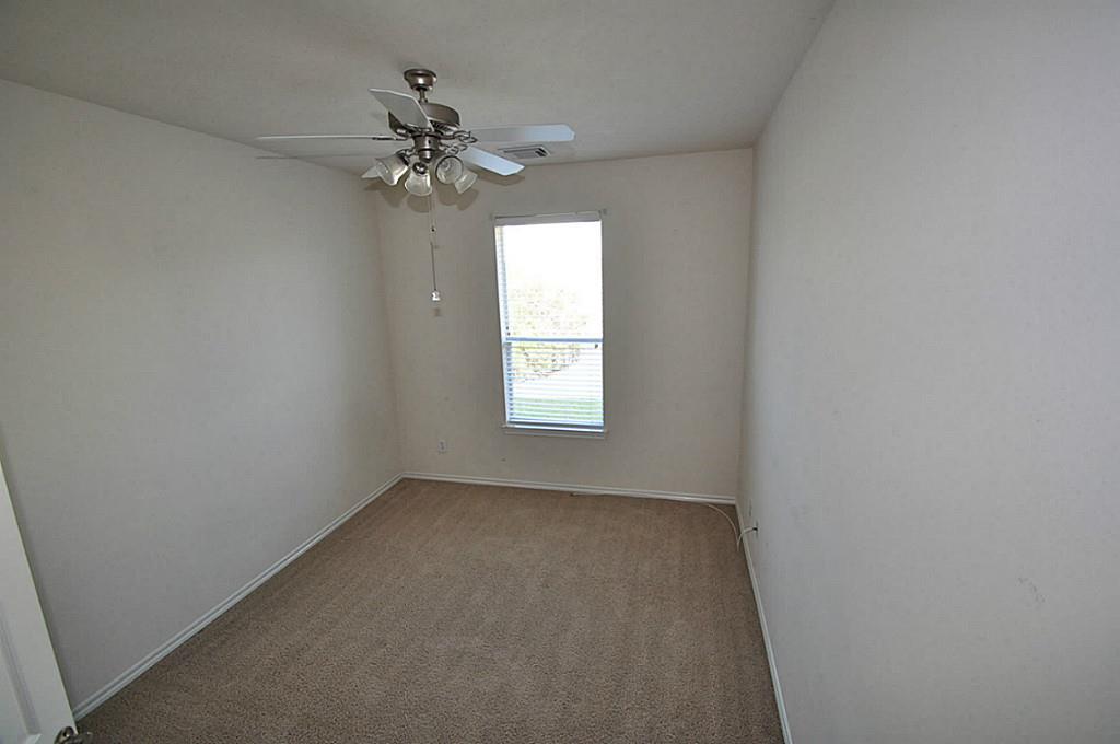 12315 Field Brook Court Houston, TX 77089 - Photo 3 of 28 an empty room that has a window and a chandelier fan