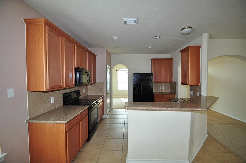 12315 Field Brook Court Houston, TX 77089 - Photo 7 of 28 a kitchen with stainless steel appliances granite countertop a sink stove and refrigerator