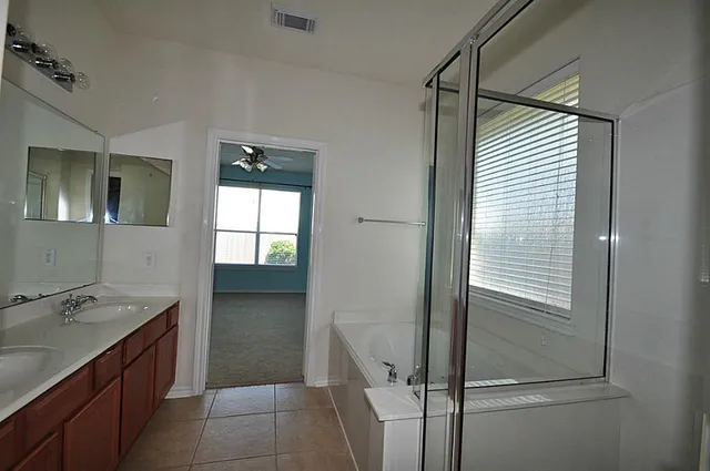 a bathroom with a shower and a sink