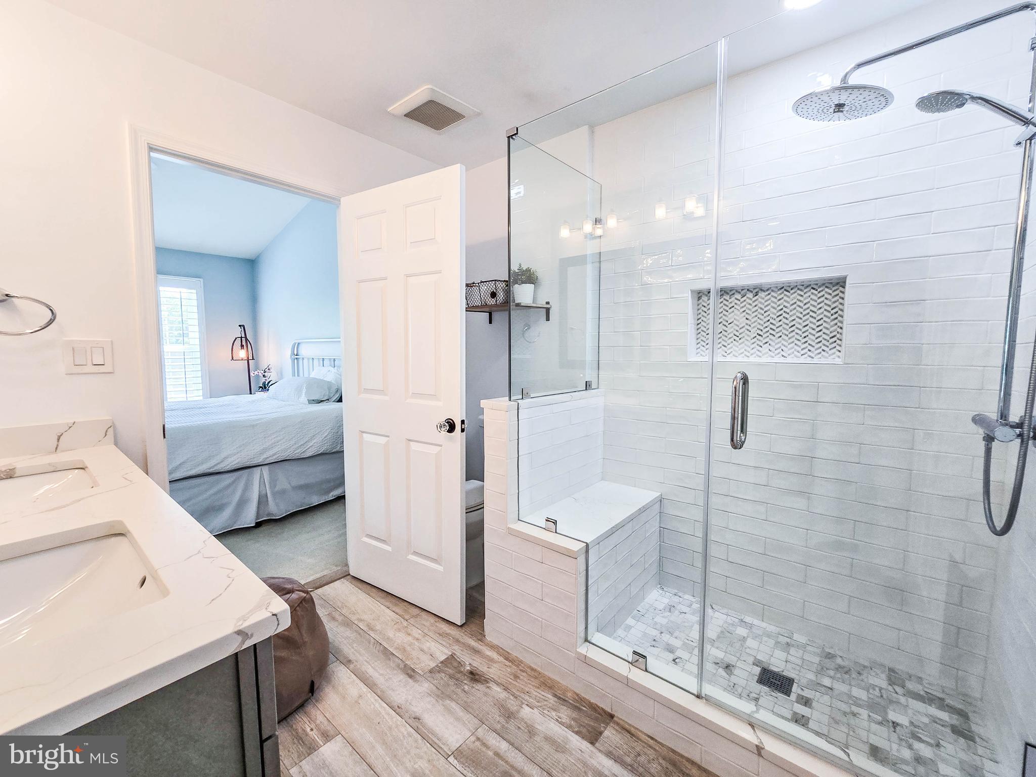 6771 Stone Maple Terrace Centreville, VA 20121 - Photo 15 of 33 a en suite spacious bathroom with a double vanity sink a mirror and shower