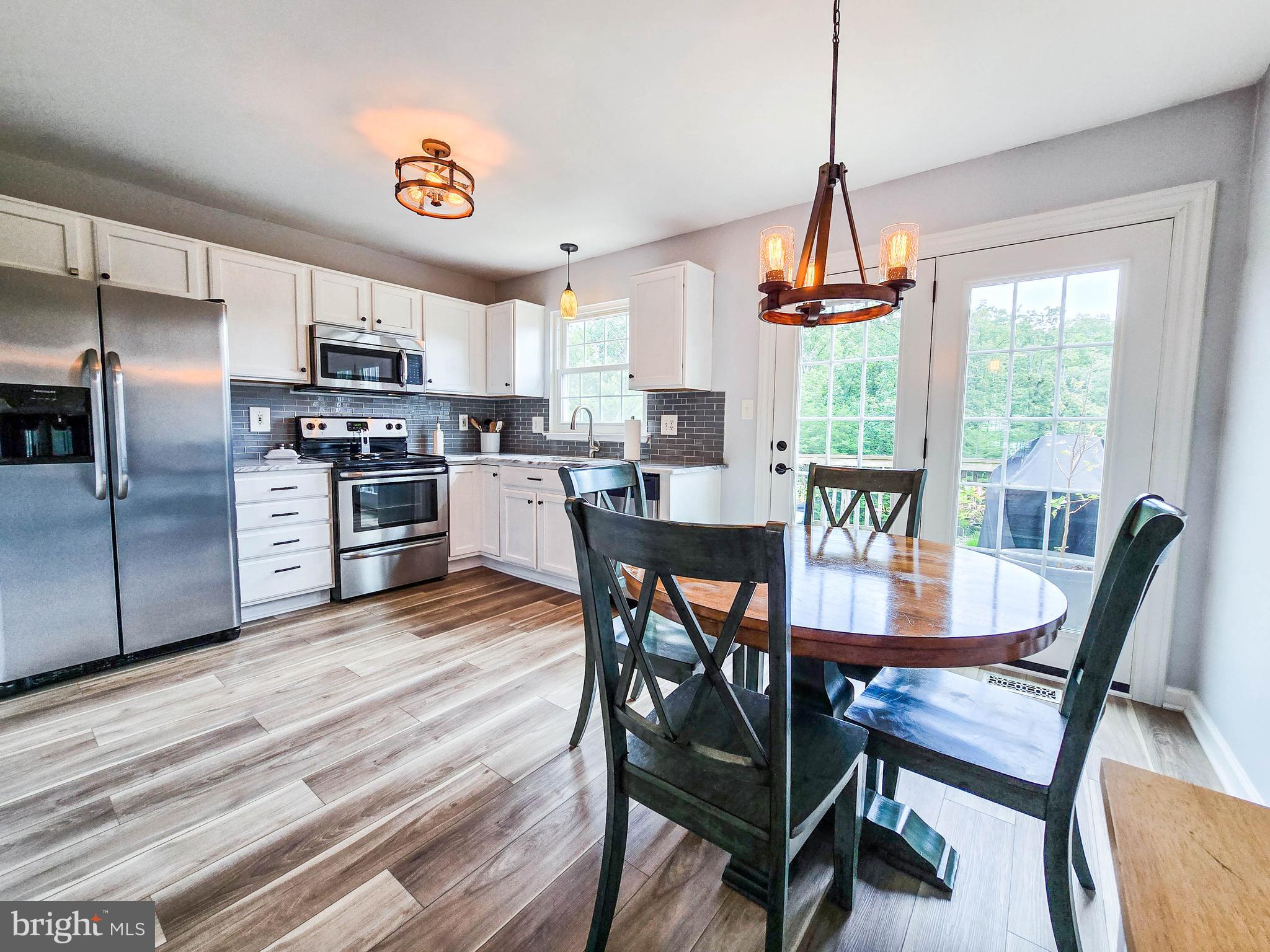 6771 Stone Maple Terrace Centreville, VA 20121 - Photo 2 of 33 a view of a dining room with furniture window and outside view