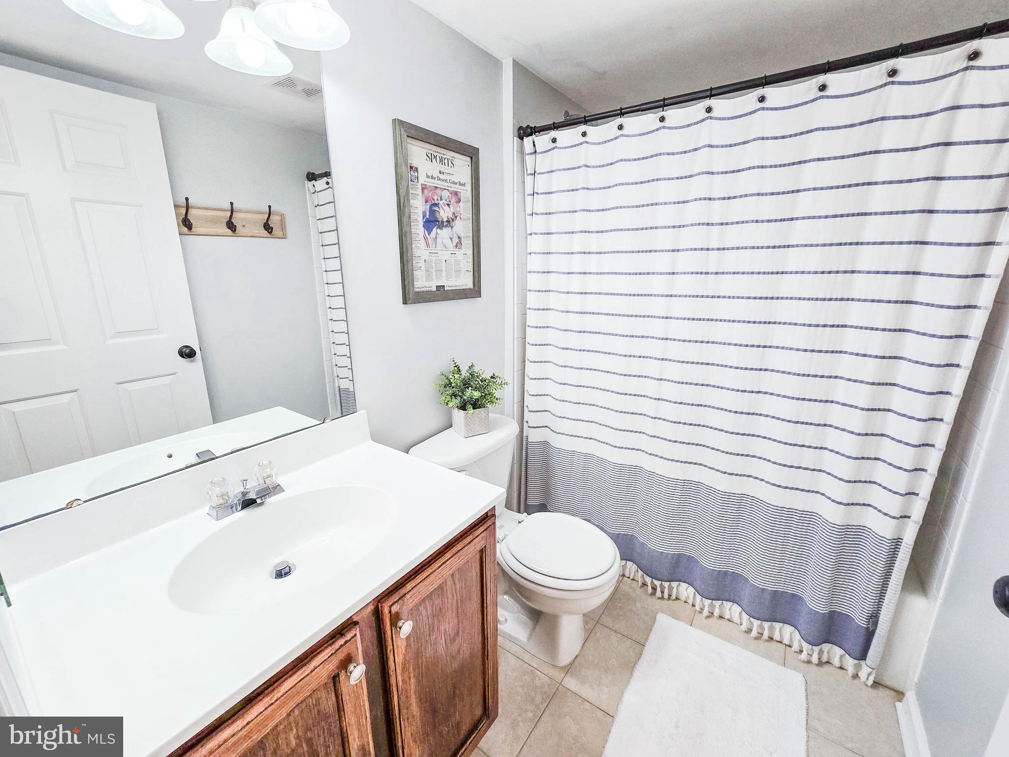 6771 Stone Maple Terrace Centreville, VA 20121 - Photo 24 of 33 a bathroom with a sink a toilet and shower curtain