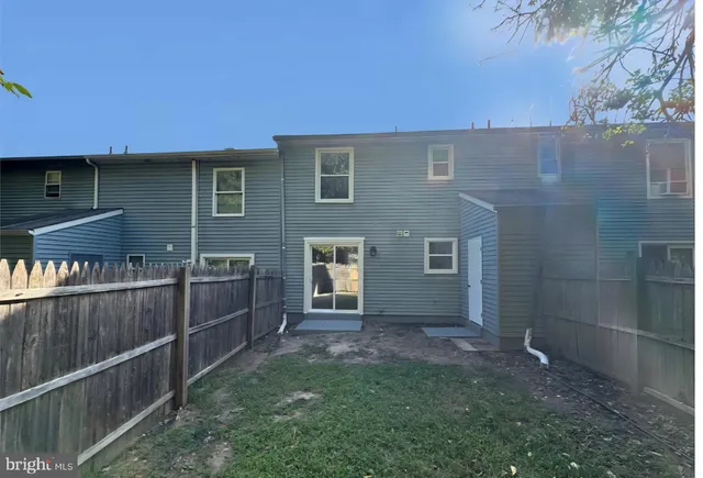a backyard of a house with barbeque oven and outdoor seating