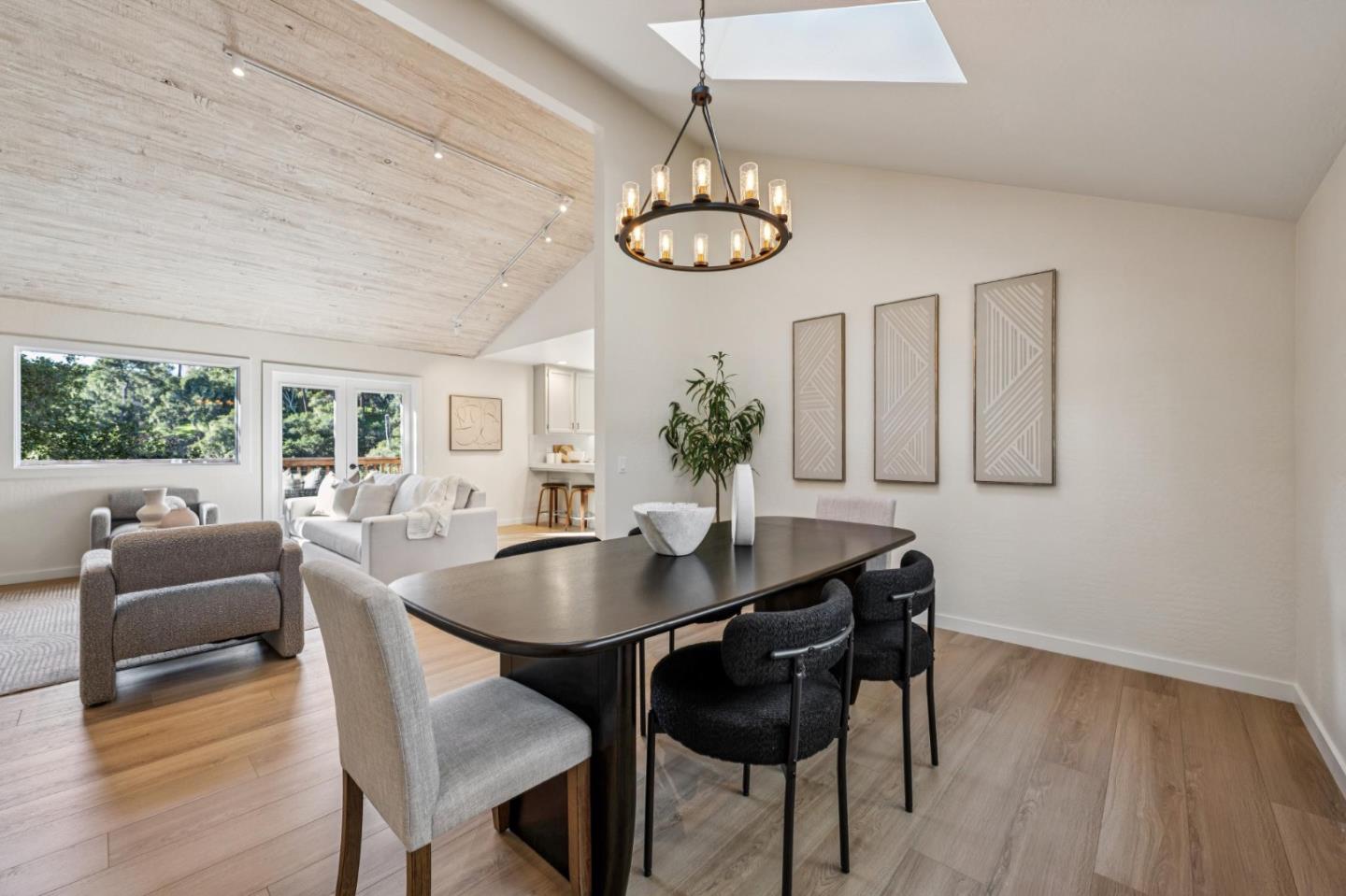1100 Castro Road Monterey, CA 93940 - Photo 22 of 70 a dining room with wooden floor a chandelier a wooden table and chairs
