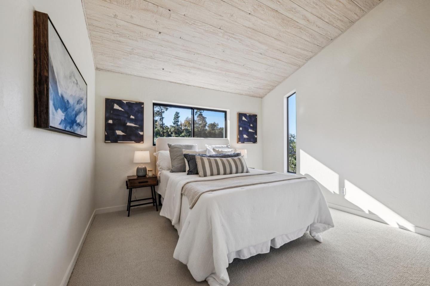 1100 Castro Road Monterey, CA 93940 - Photo 43 of 70 a bedroom with a bed lamp closet and large window