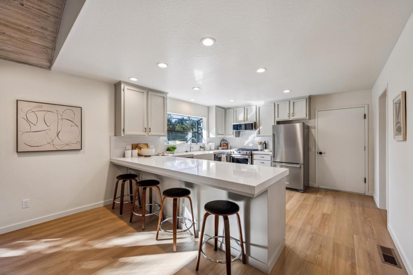 1100 Castro Road Monterey, CA 93940 - Photo 6 of 70 a kitchen with stainless steel appliances a table and chairs