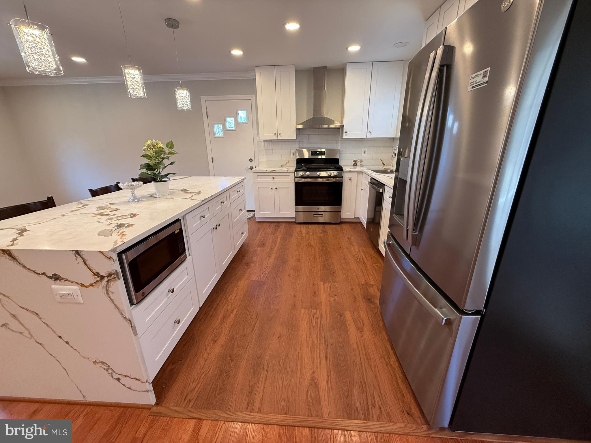 4721 Springbrook Drive Annandale, VA 22003 - Photo 21 of 69 a kitchen with stainless steel appliances a refrigerator a sink a stove a microwave and cabinets