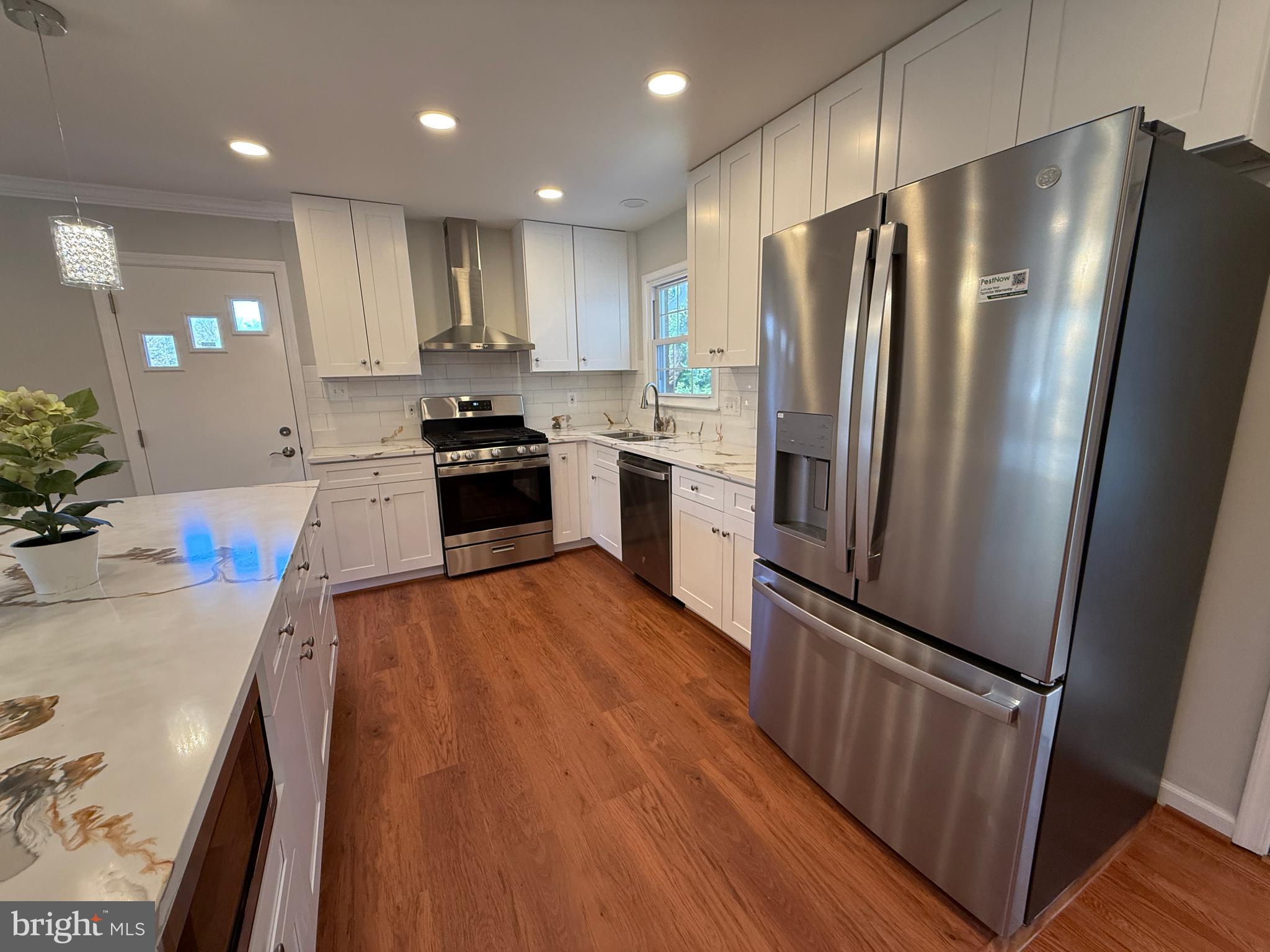 4721 Springbrook Drive Annandale, VA 22003 - Photo 22 of 69 a kitchen with granite countertop stainless steel appliances a refrigerator a stove top oven and sink