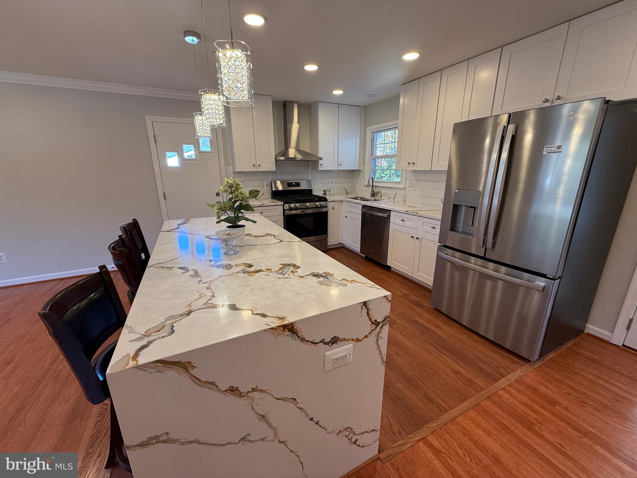 4721 Springbrook Drive Annandale, VA 22003 - Photo 36 of 69 a kitchen with stainless steel appliances kitchen island granite countertop a refrigerator and a stove top oven