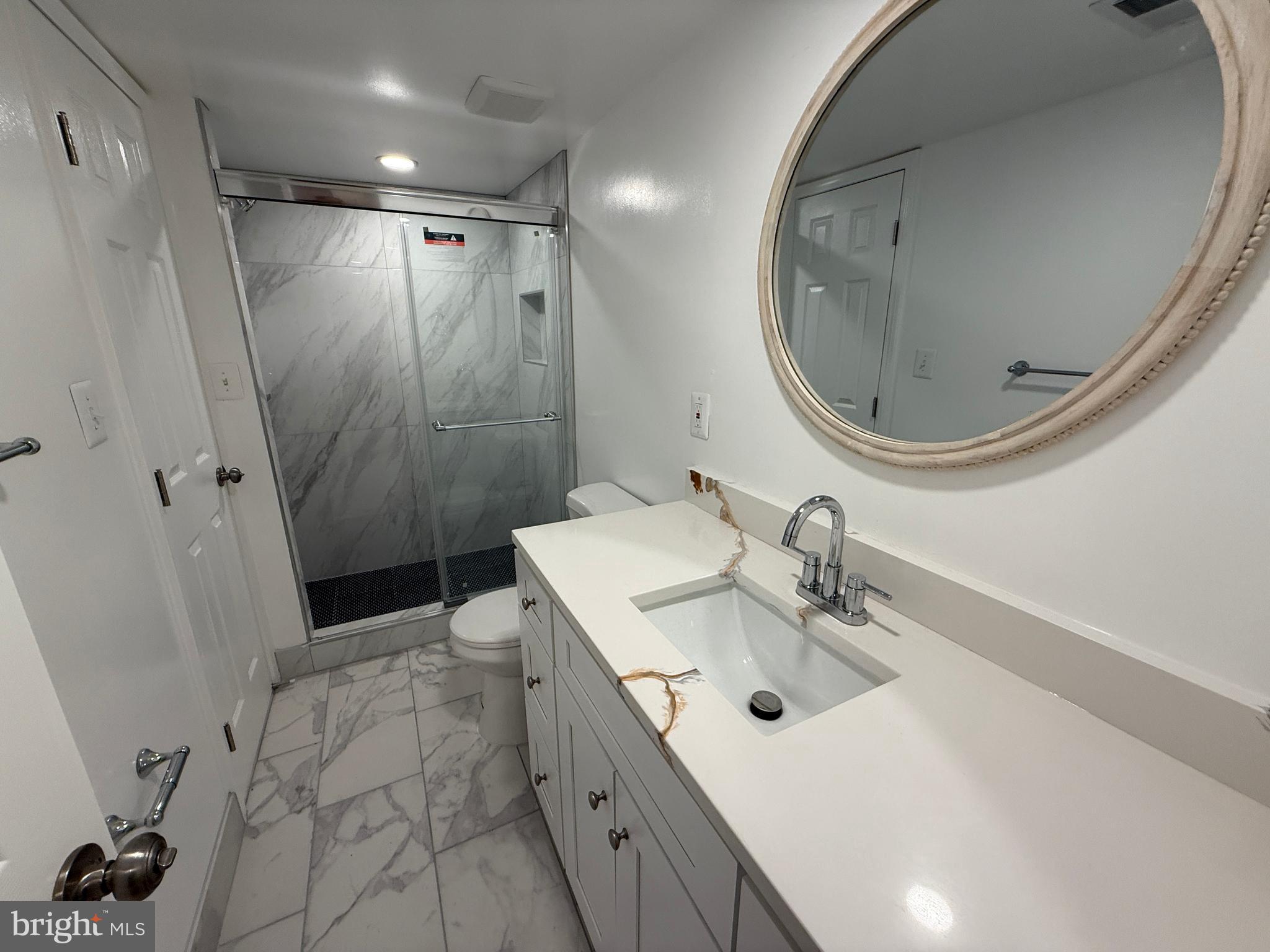 4721 Springbrook Drive Annandale, VA 22003 - Photo 46 of 69 a bathroom with a sink mirror toilet and shower