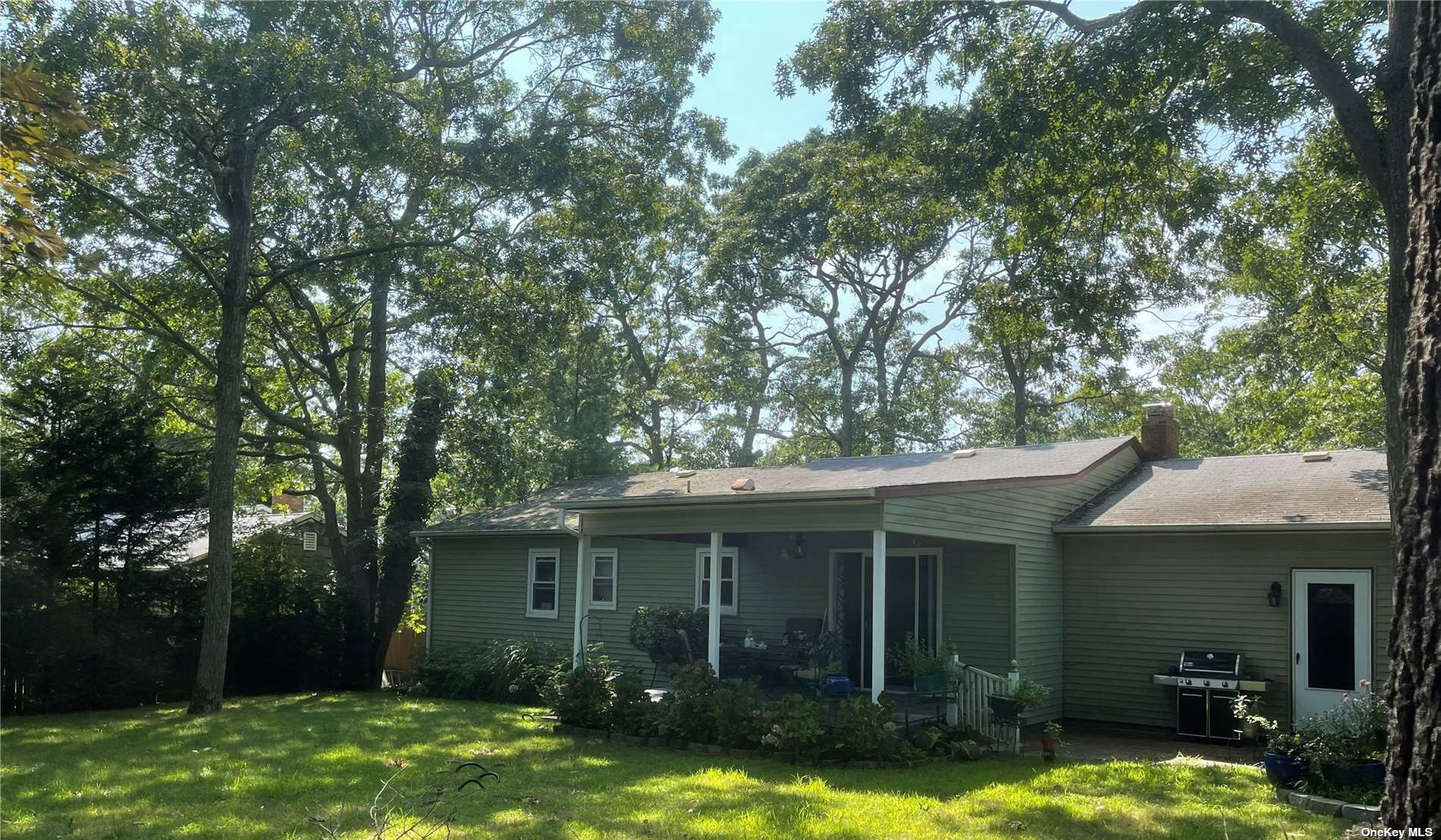 a view of a house with backyard porch and sitting area