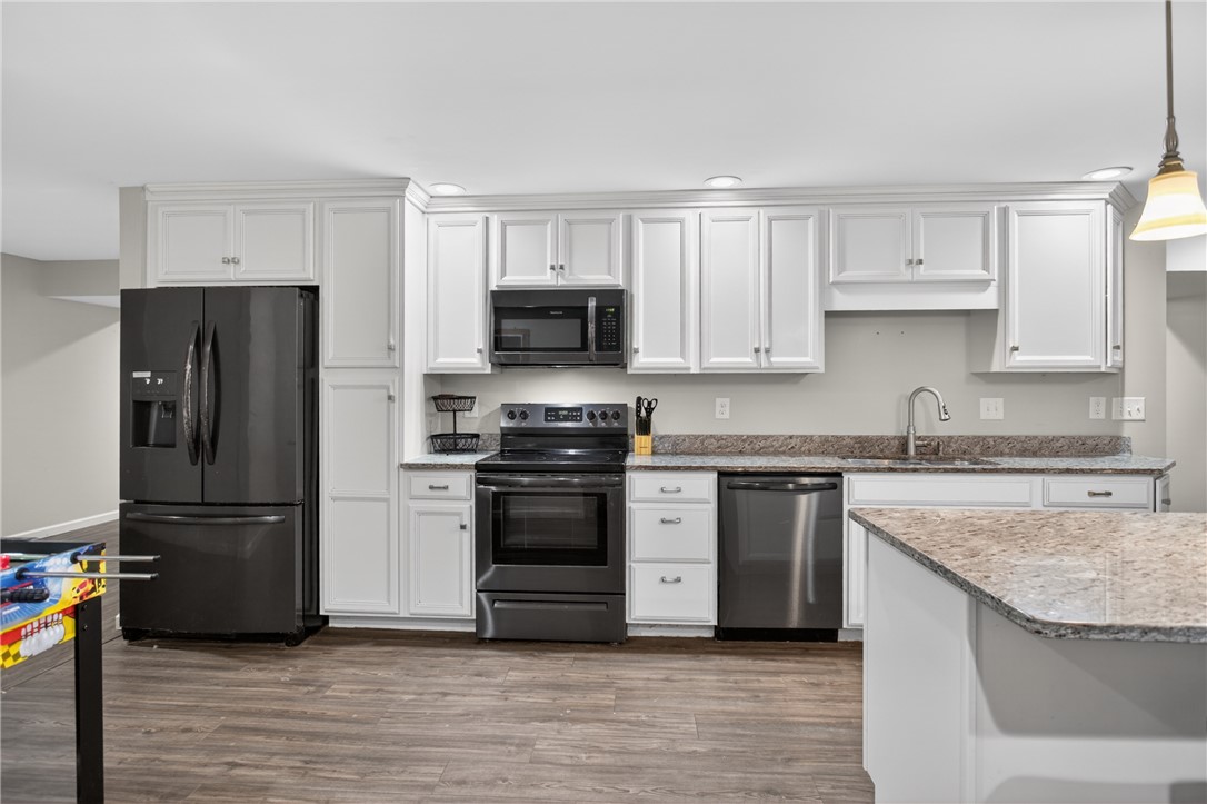 136 Loran Pointe Circle Seneca, SC 29672 - Photo 27 of 50 A well-appointed kitchen features ample white cabinetry complemented by stone countertops and modern appliances.