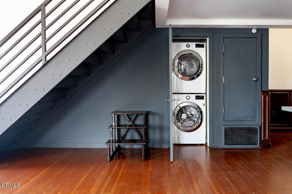 257 South Spring Street, Unit PHE Los Angeles, CA 90012 - Photo 15 of 32 a view of washer and dryer with wooden floor