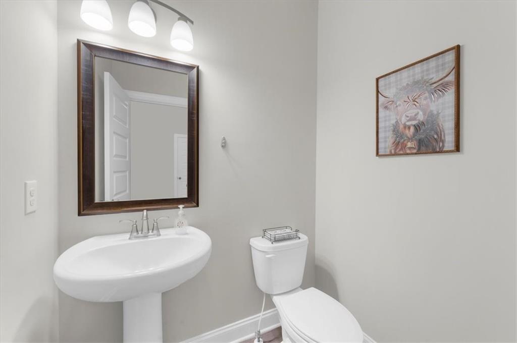 182 Bella Drive Monroe, GA 30655 - Photo 13 of 63 a bathroom with a toilet sink and mirror