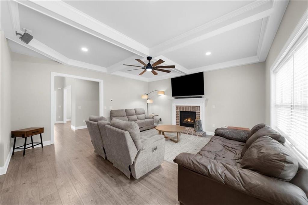 182 Bella Drive Monroe, GA 30655 - Photo 15 of 63 a living room with furniture a fireplace and a flat screen tv