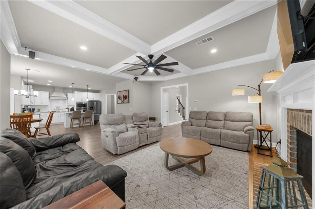 182 Bella Drive Monroe, GA 30655 - Photo 17 of 63 a living room with furniture a rug and a flat screen tv