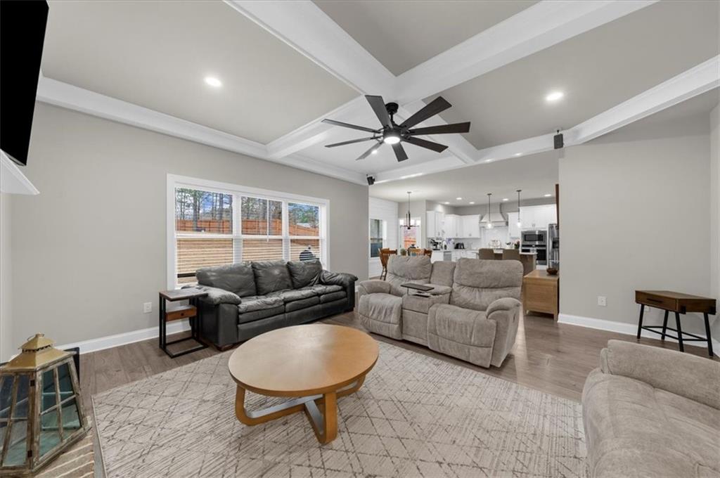 182 Bella Drive Monroe, GA 30655 - Photo 18 of 63 a living room with furniture a ceiling fan a rug and a window
